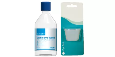 A bottle of saline solution and an eye bath